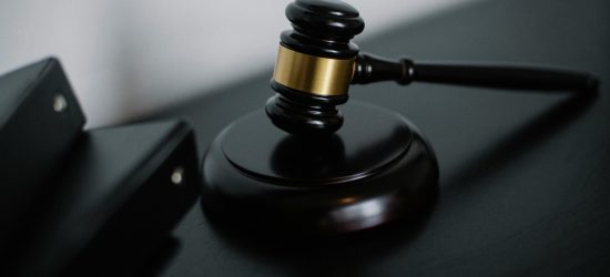 Close-up of a wooden gavel on a desk, symbolizing justice and legal authority.